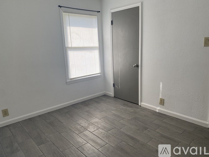 A room with a door, window, and tiled floor.