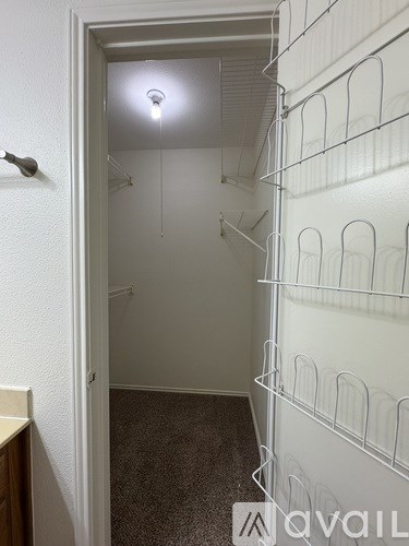 A white wall with a door and a light on.