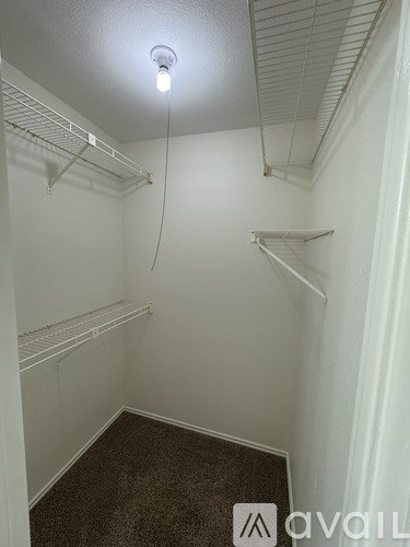 A small, empty room with a single light bulb on the ceiling.