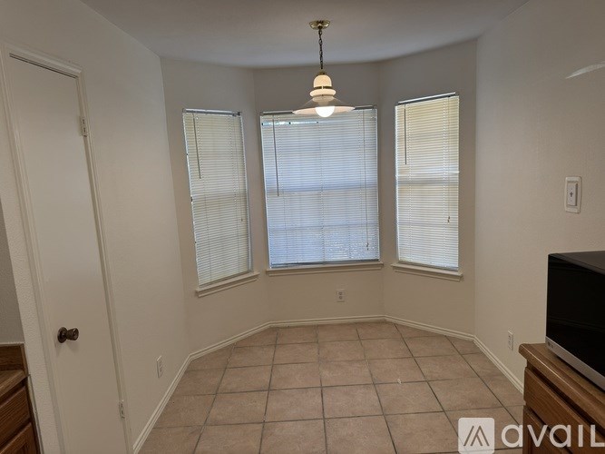 A room with a tiled floor and a television on the right side.