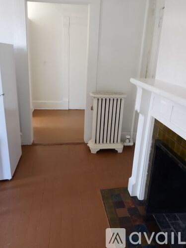 A room with a fireplace and a radiator.