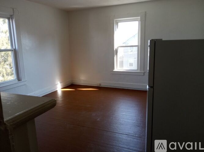 A room with wooden floors and a window.