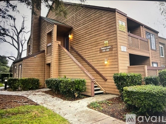 A wooden building with a sign that says "Tulip Clint" and a phone number.