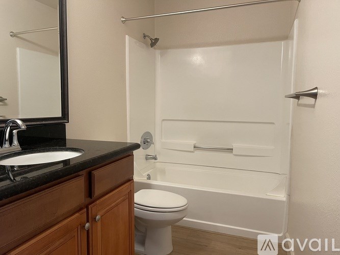 A bathroom with a toilet, sink, and bathtub.