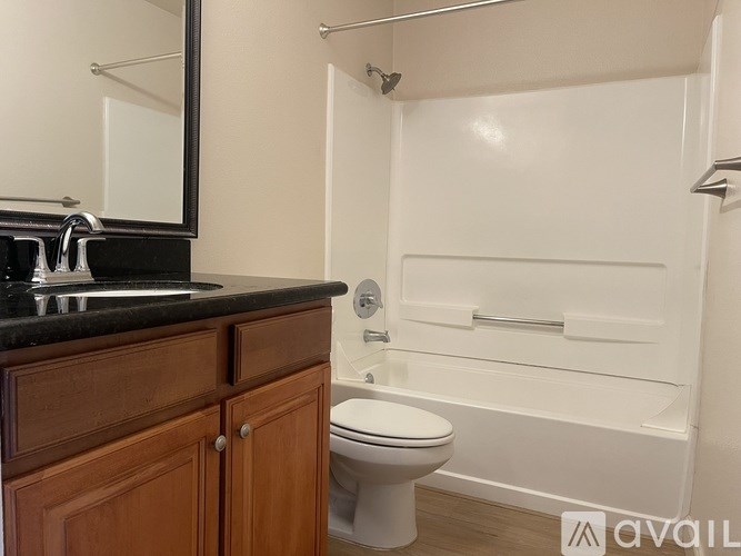A bathroom with a toilet, sink, and bathtub.