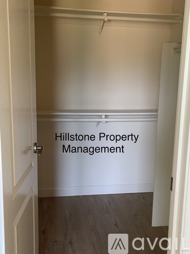 A white door with a sign that says Hillstone Property Management.