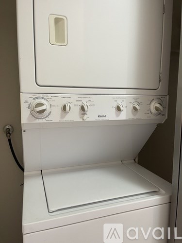 A white oven with a door and knobs on the front.