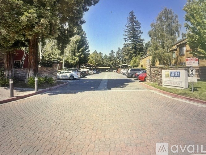 A sunny day at Sierra Estates with a clear blue sky and a few cars parked.