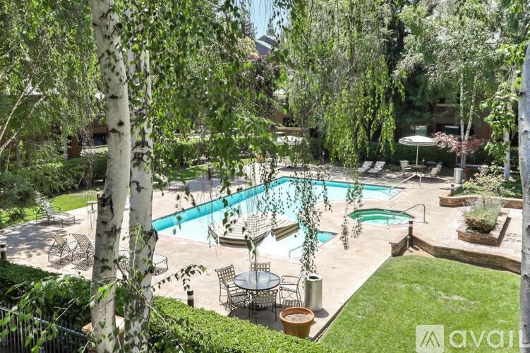 A backyard with a pool and a patio table.