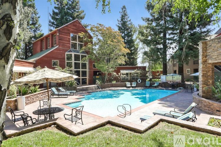 A red house with a pool in the backyard.