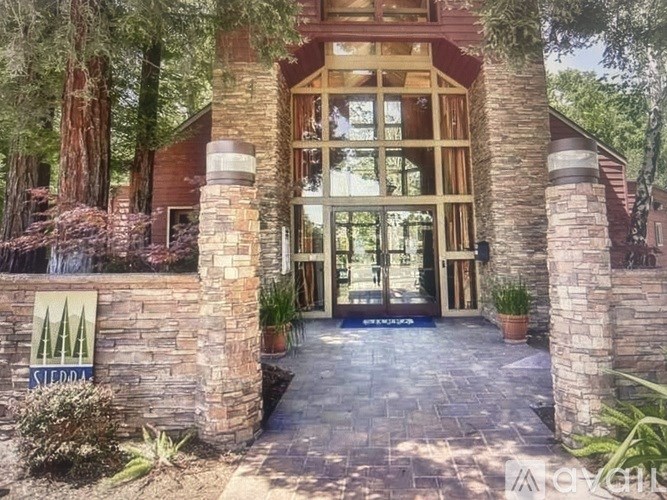 A house with a stone wall and a sign that says Sierra.
