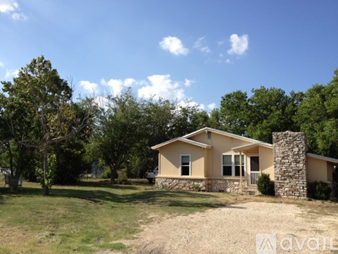 A house with a stone pillar in front of it.
