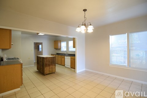 A kitchen area with wooden cabinets and a countertop.