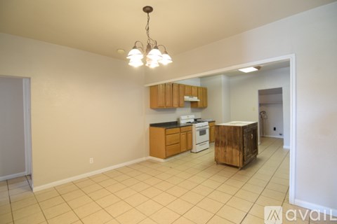 A kitchen area with wooden cabinets and a white oven.