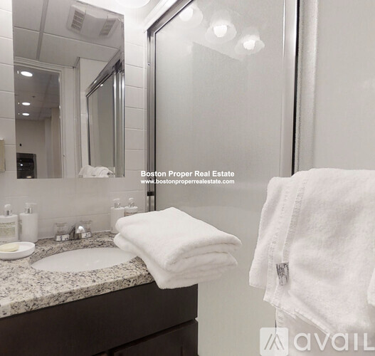 A white towel is folded on a bathroom counter.