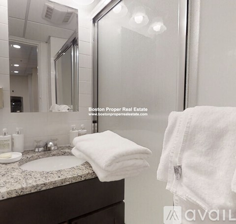 A white towel is folded on a bathroom counter.