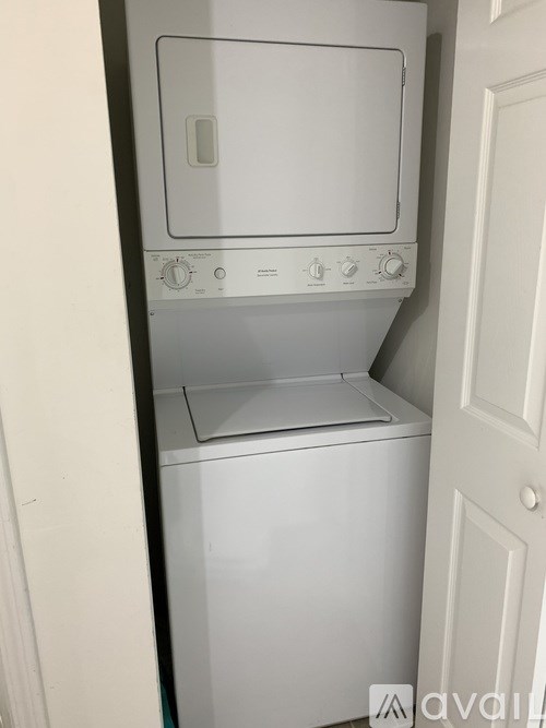 A white washing machine and dryer in a small laundry room.