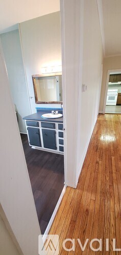A bathroom with a sink and mirror.