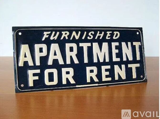 A black and white sign that says "Furnished Apartment for Rent".