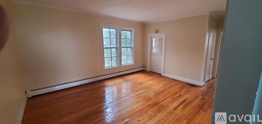 A room with wooden floors and a window.