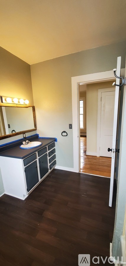 A bathroom with a vanity and a mirror.