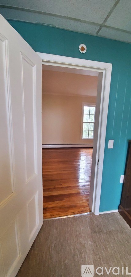 A room with a white door and a window.