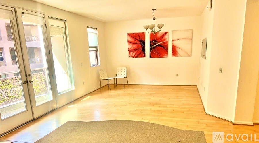 A room with a brown rug and a white chair.