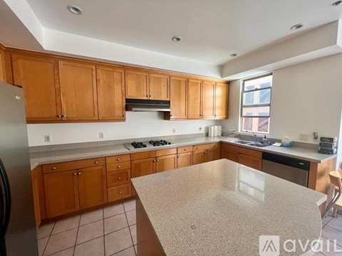 A kitchen with wooden cabinets and a granite countertop.
