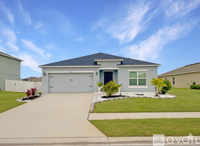 A two-story house with a garage and a driveway.