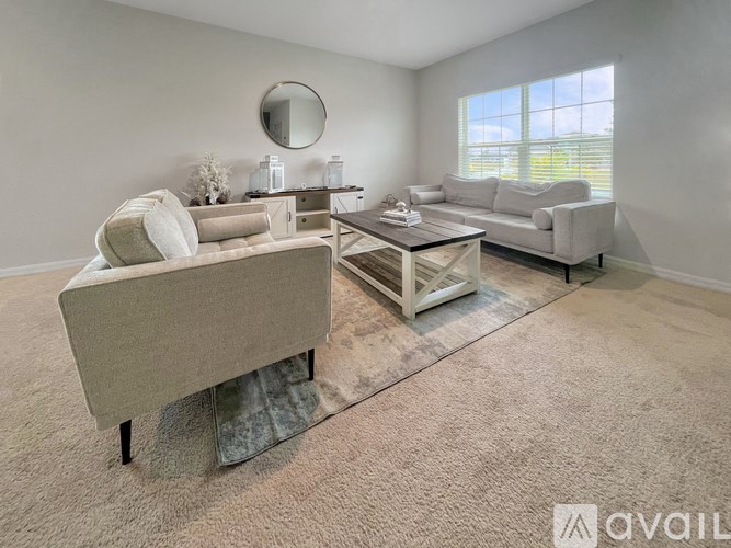 A living room with a sofa, a chair, and a coffee table.