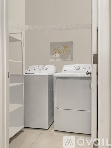 A white washing machine and dryer in a small laundry room.