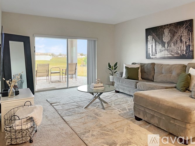 A living room with a couch, a coffee table, and a large mirror.