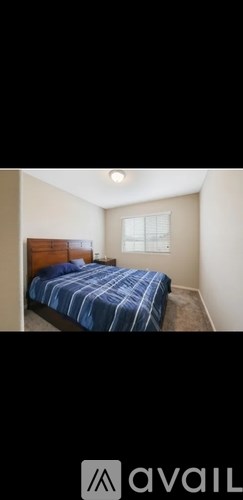 A bedroom with a bed and a window.