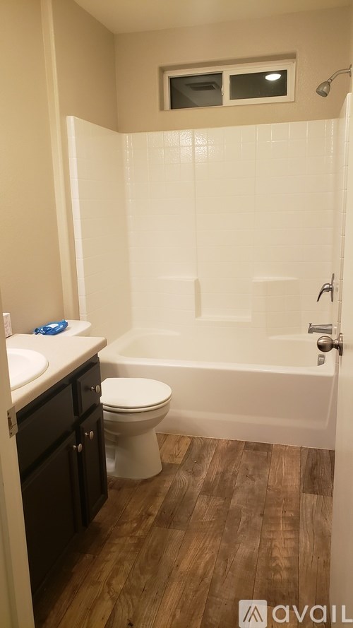 A bathroom with a toilet, sink, and bathtub.