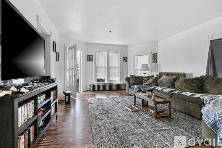 A living room with a couch, a television, and a coffee table.