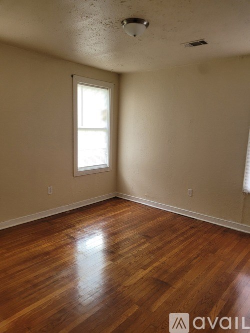 A room with wooden floors and a window.