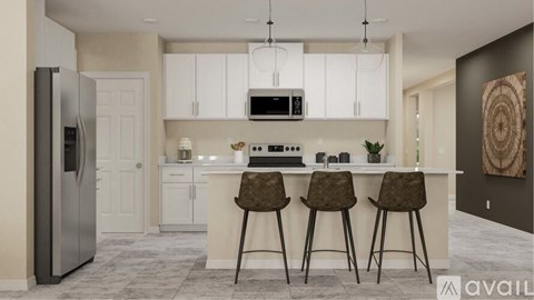 A modern kitchen with white cabinets and a center island.