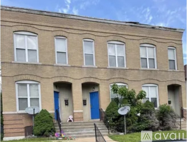 A building with blue doors and windows is for sale.