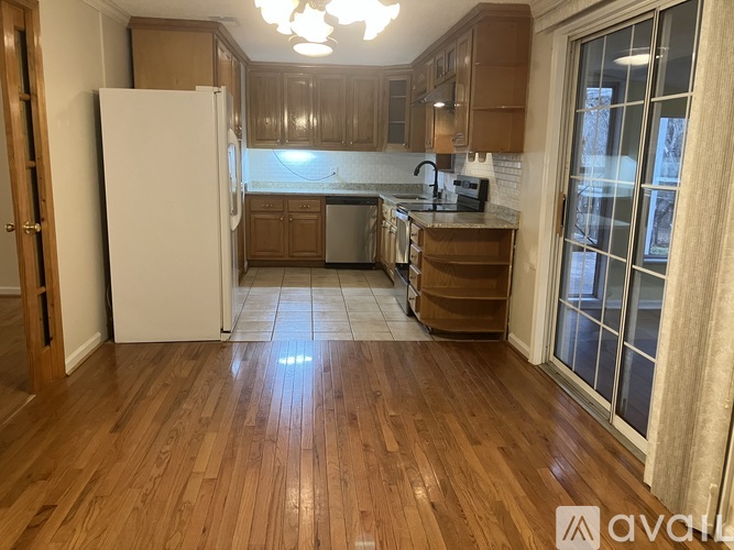 A kitchen with a white stove top oven and a white dishwasher.