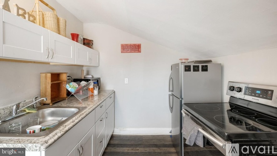 A kitchen with a stove top oven and a sink.