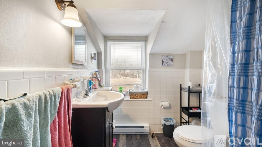 A bathroom with a towel hanging on the rack.