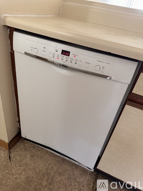 A white dishwasher with a digital display and control panel.
