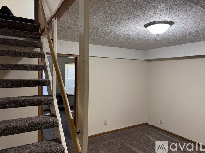 A room with a staircase leading to the upper floor.