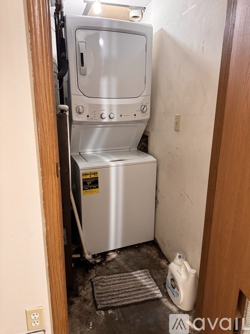 A white washing machine is in a small room.
