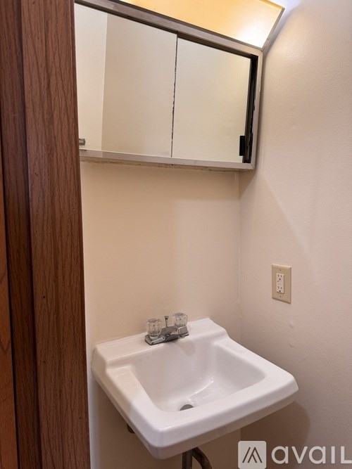 A white sink in a small bathroom.