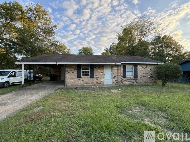 A house with a white van parked in front.