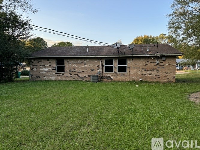 A small, old, and abandoned house with a broken window and a missing door.