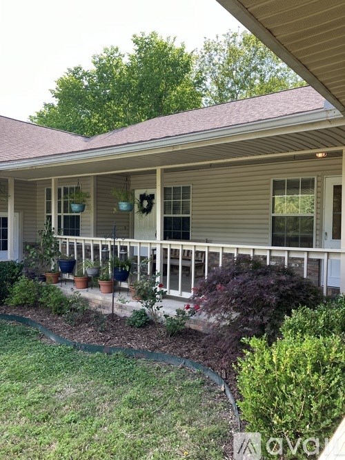 A house with a porch and a wreath on the door.