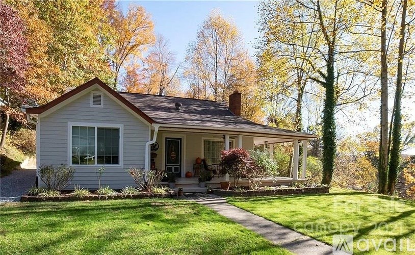 A house with a well-kept lawn in front of it.