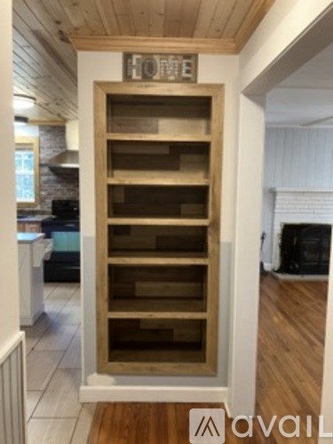 A wooden shelving unit with the word HOME on top.
